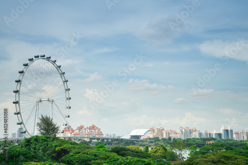 Photography Singapore Ferris wheel with building and green park at Marina Barrage  is the park for outdoor activities