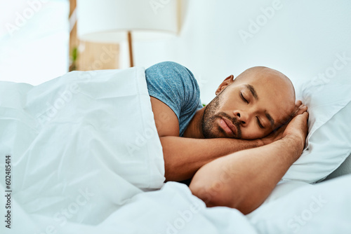 Foto Relax, sleeping and man in bed, home and wellness with peace, comfortable or happiness