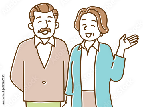 笑顔でこちらを見て手を挙げるシニア夫婦
