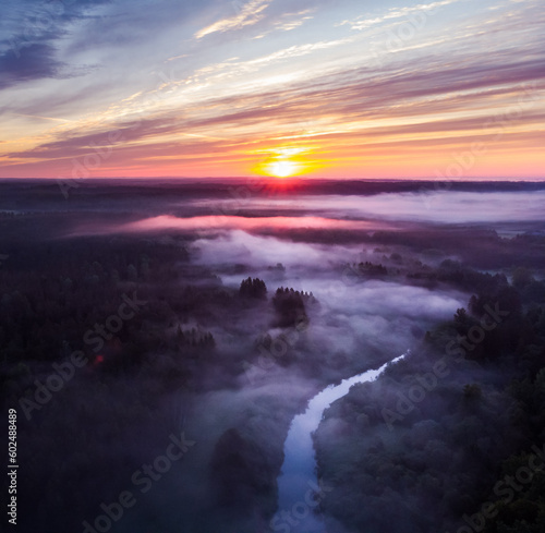 Drone s Eye View  Serene Sunrise Over Misty River and Woodland Landscape in Northern Europe