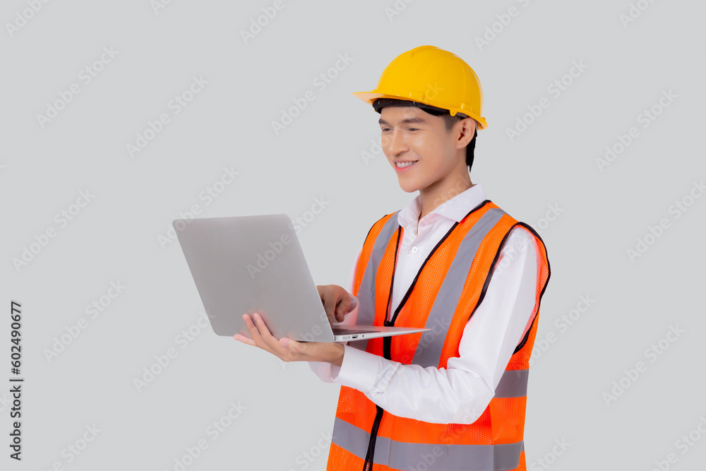 Portrait young asian engineer man looking laptop computer for planning isolated white background, architect or contractor check and diagnostic for inspection with notebook, industrial concept. Portrait young asian engineer man looking laptop computer for planning isolated white background, architect or contractor check and diagnostic for inspection with notebook, industrial concept.