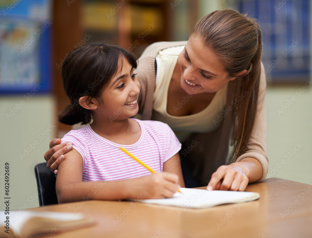 Study, education or learning with a student and teacher in a classroom together for writing or child development. School, scholarship and teaching with a woman educator helping a girl child in class Study, education or learning with a student and teacher in a classroom together for writing or child development. School, scholarship and teaching with a woman educator helping a girl child in class