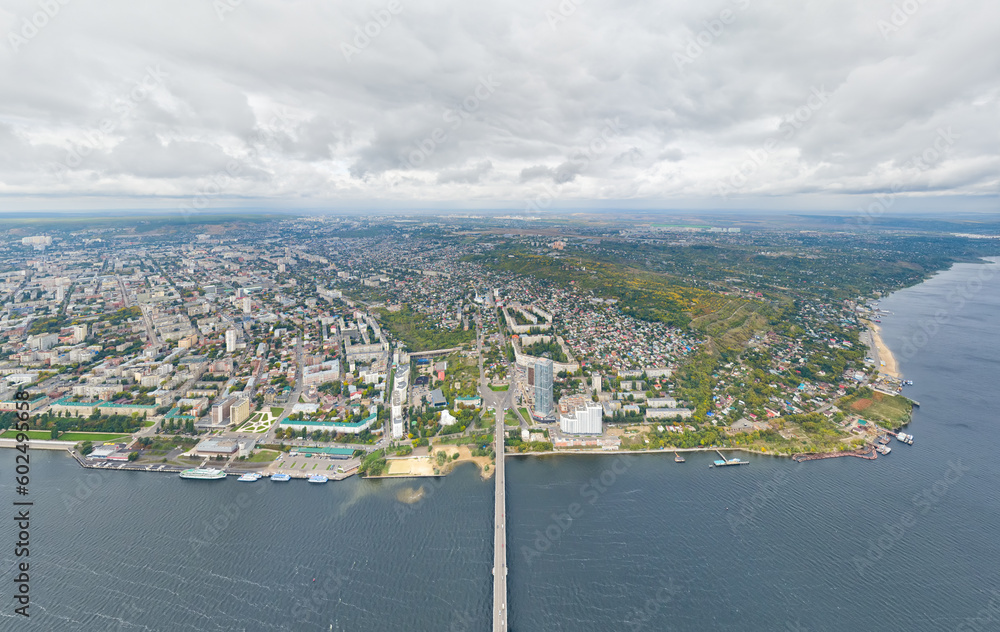 Saratov, Russia. Panorama of the city and the Saratov bridge across the Volga river. Cloudy weather. Aerial view