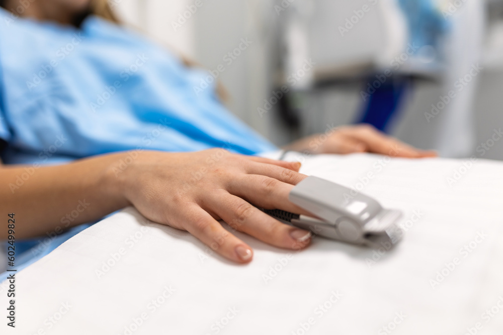 Closeup of hand with finger pulse oximeter. Using finger pulse oximeter, monitoring vital sign, Medical concept. Bedroom or hospital room for young patien Closeup of hand with finger pulse oximeter. Using finger pulse oximeter, monitoring vital sign, Medical concept. Bedroom or hospital room for young patien
