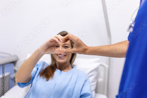 Doctor and patient make finger heart shape , professional medical safety and hygiene protection from Coronavirus disease COVID-19 and surgery photo