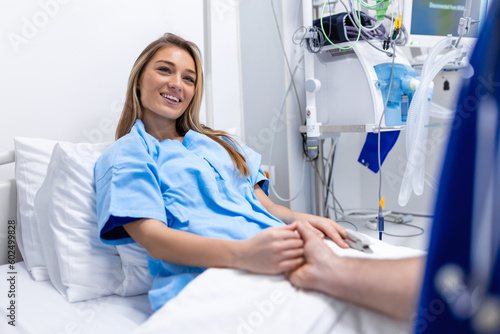 Healthcare concept of professional doctor consulting and comforting patient in hospital bed or counsel diagnosis health. Medical doctor or nurse holding patient's hands and comforting her