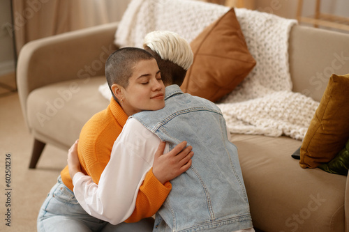 Young lesbian woman couple supporting each other, reconciling after quarrel photo