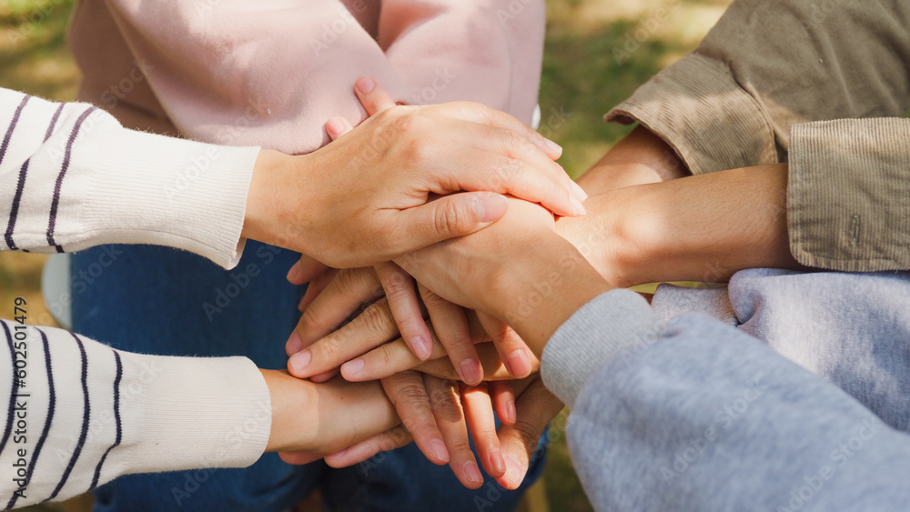© tirachard - Close-up of diverse multiracial men and women group sit in circle hold hands together hope for help people in park. Support and understand at psychological therapy session, PTSD Mental health concept. © tirachard - Close-up of diverse multiracial men and women group sit in circle hold hands together hope for help people in park. Support and understand at psychological therapy session, PTSD Mental health concept.