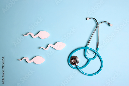 Картината върху платно Sperm cells with stethoscope on blue background.