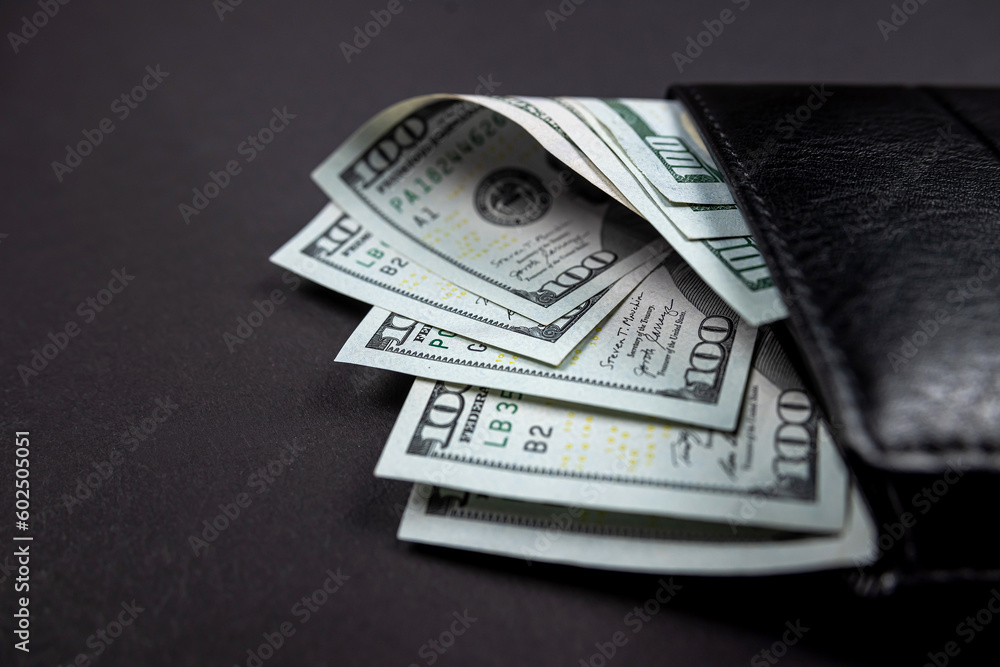brown leather wallet with what appears to be US dollar money inside. brown leather wallet with what appears to be US dollar money inside.