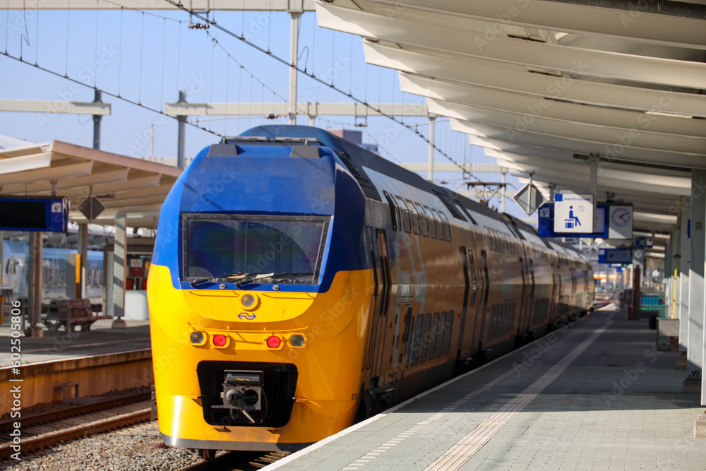 Refurbished VIRM intercity doubledek train along platform at station
