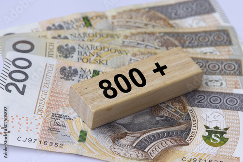 Inscription 800 plus next to 200 Polish zloty banknotes. 800 plus is evaluation of the 500 plus program in Poland, state program in the field of social policy.