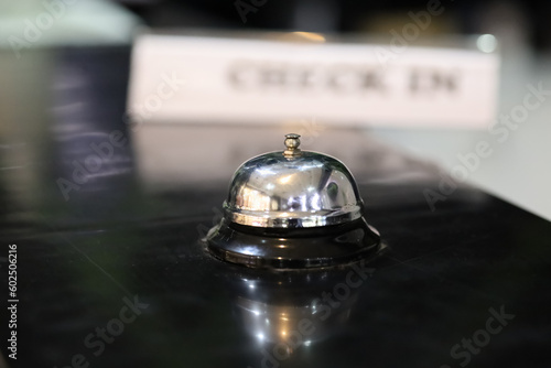 Hotel service bell on black table in hotel lobby Travel, room, accommodation and lodging concept