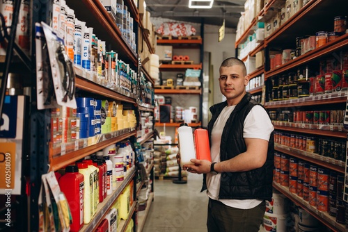 Fotografie Caucasian consultant in uniform at hardware store