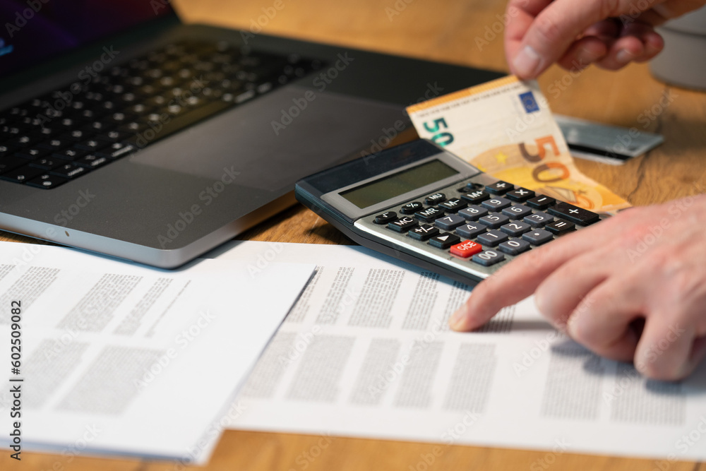 Financial documents. A banknote with a calculator in the background. Euro currency. Financial documents. A banknote with a calculator in the background. Euro currency.