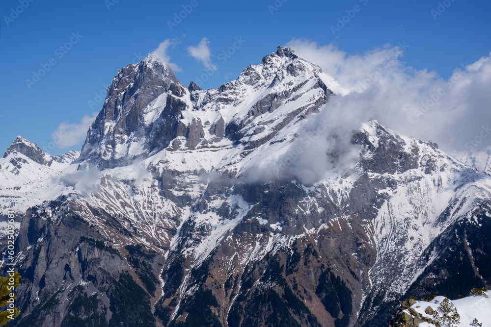 Obraz premium View of stunning snowcapped mountain peaks against blue sky in Swiss Alps. Canton Uri, Switzerland, Europe.