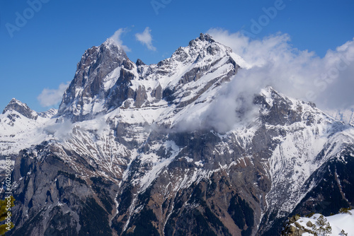 View of stunning snowcapped mountain peaks against blue sky in Swiss Alps. Canton Uri, Switzerland, Europe.