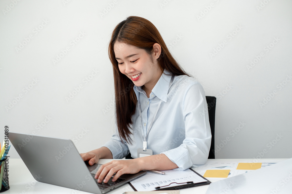 Beautiful young asia businesswoman’s sitting in the office room and using computer to plan about marketing investment for her business. Beautiful young asia businesswoman’s sitting in the office room and using computer to plan about marketing investment for her business.