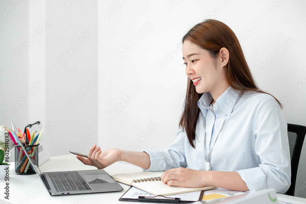 Beautiful young asia businesswoman’s sitting in the office room and using computer to plan about marketing investment for her business. Beautiful young asia businesswoman’s sitting in the office room and using computer to plan about marketing investment for her business.