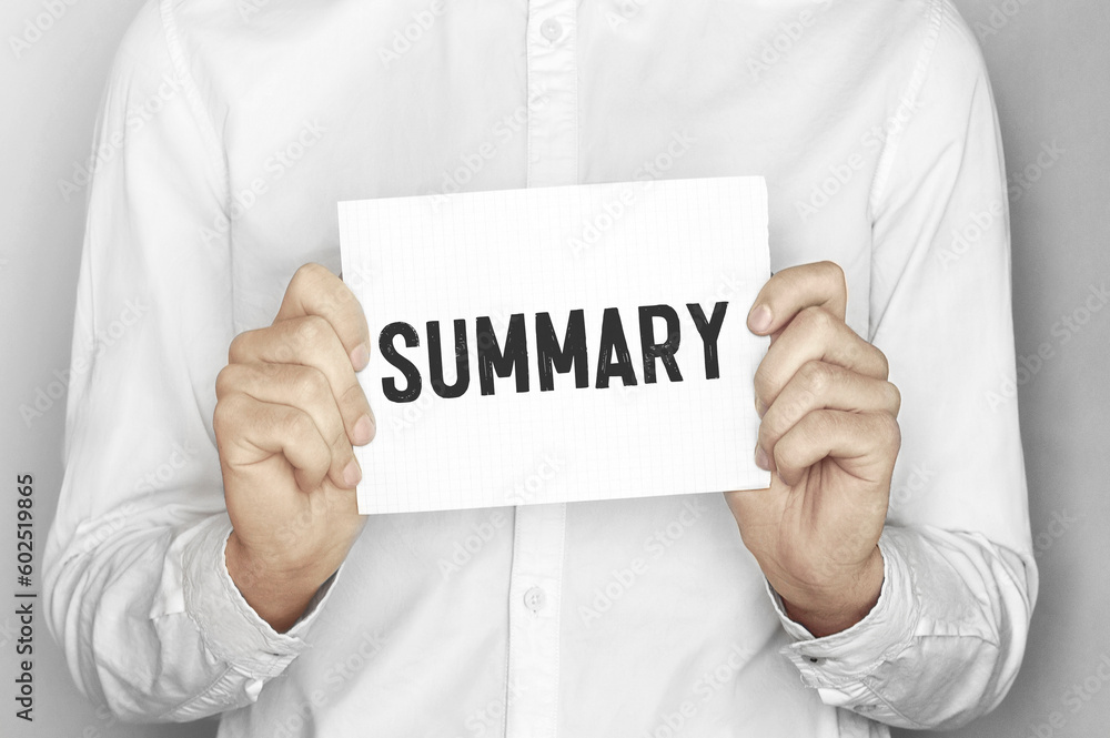 Man holding a paper card with text Summary Man holding a paper card with text Summary
