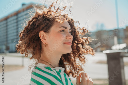 Smiling young woman with curly hair photo