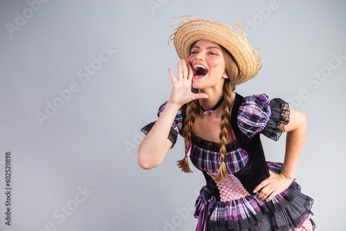 Blonde Brazilian woman, June party clothes, arraial. shouting promotion. photo