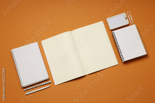 Mockup flat lay with different office accessories on brown background
