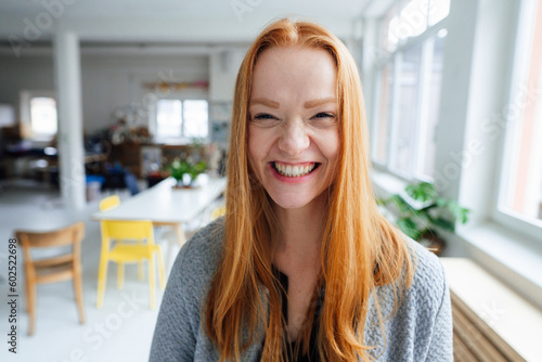 Young happy redhead businesswoman at office photo