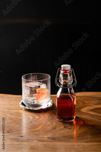 Unusual restaurant serving cocktail, cocktail bottle and glass with ice