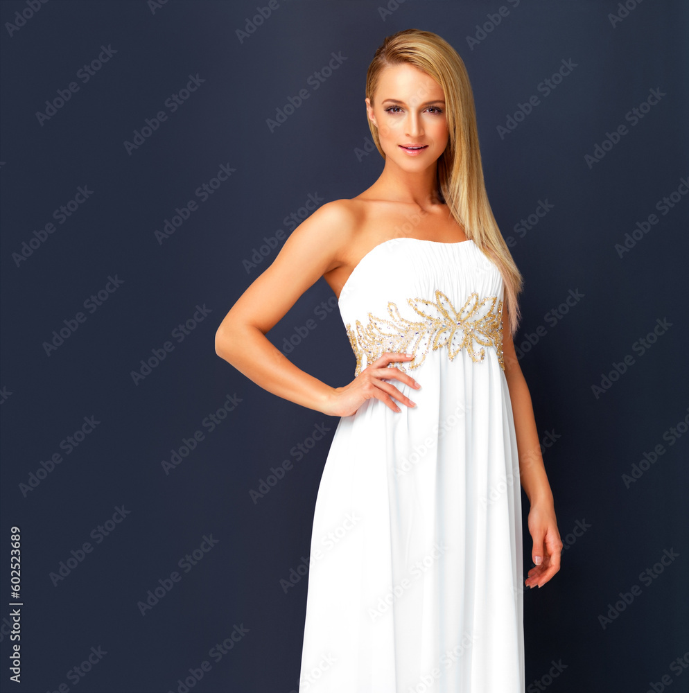 Beautiful woman in a white gala dress and looking gorgeous for prom, orcars or red carpet event. Portrait a fashion and beauty model looking posh in a designer gown with copy space background