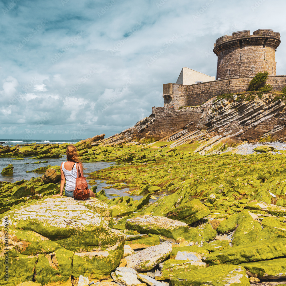 French woman looking at Socoa Fort in Ciboure- Saint Jean de Luz- tourism in France,  Basque country, Nouvelle aquitaine - obrazy, fototapety, plakaty 