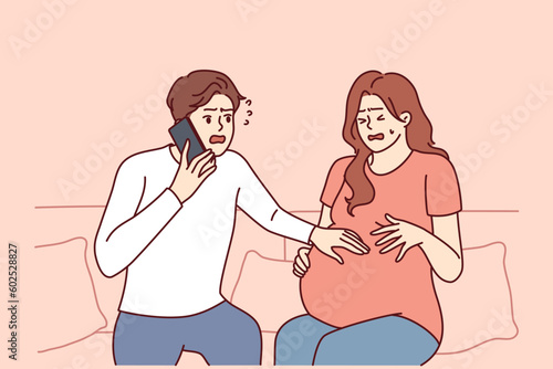 Pregnant woman next to worried husband calling doctor or 911 to report wife birth or marriage. Frightened man uses phone to tell prenatal doctor about pregnant bride stomach pains.