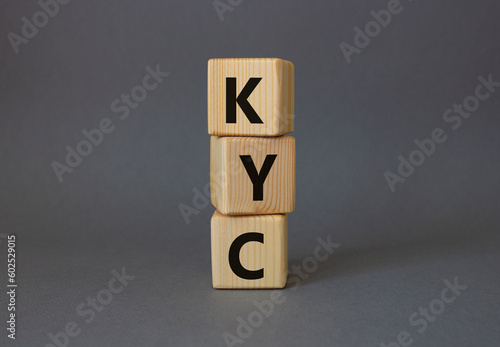 KYC - Know Your Customer. Wooden cubes with word KYC. Beautiful grey background. Business and Know Your Customer concept. Copy space.
