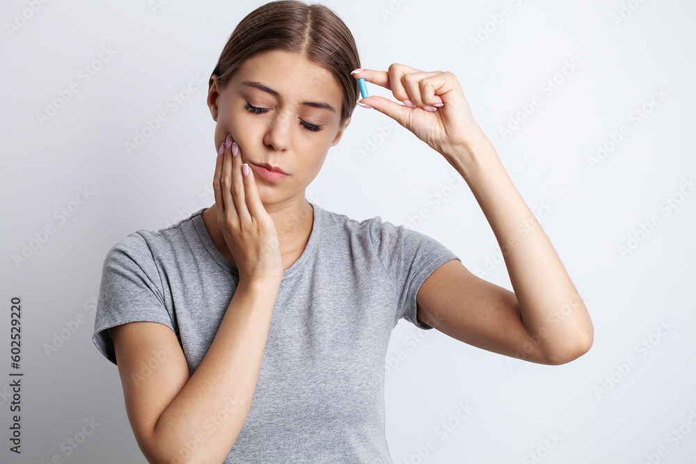 Woman suffering from tooth pain and touching cheek Woman suffering from tooth pain and touching cheek