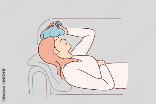 Woman suffers from hangover and puts ice pack on head to get rid of headache after alcohol party