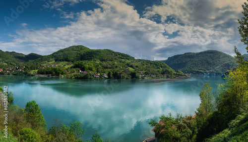Drina river and green hills on a summer day. Beautiful panoramic landscape shot. The beauty of nature in the Balkans
