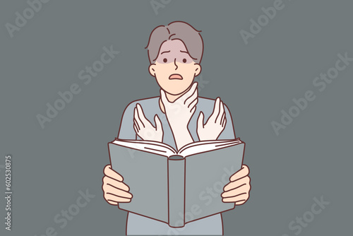 Man reads book with scary story and imagines hands reaching for his neck to choke him