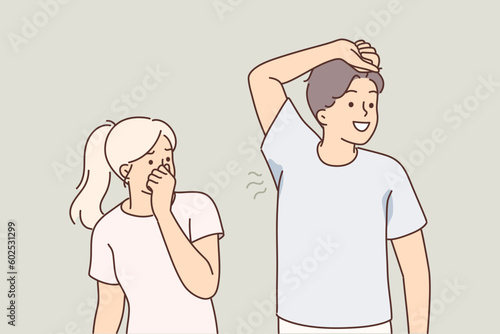 Man with sweaty armpit emitting unpleasant odor near woman who is disgusted and pinches nose