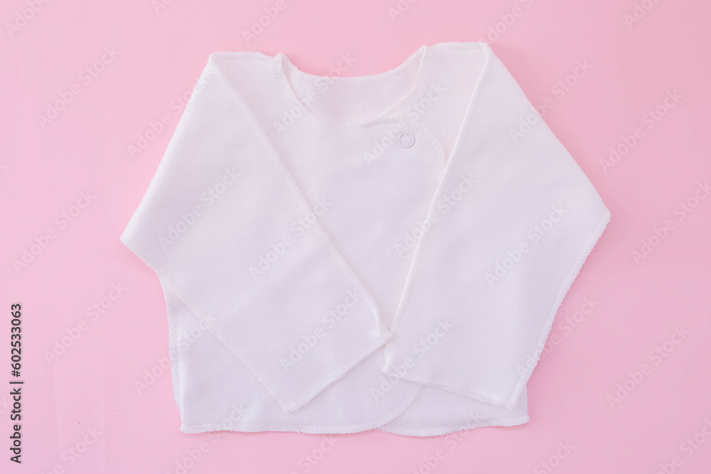 White vest on a pink background. Waiting for the girl. Pregnancy. Clothes for newborns White vest on a pink background. Waiting for the girl. Pregnancy. Clothes for newborns