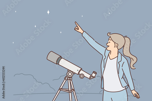 Woman with telescope points finger at starry sky, being fond of astronomy and watching space