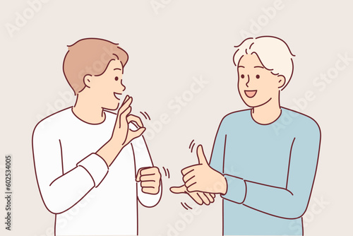Man teaches friend sign language to be able to communicate with people with hearing problems