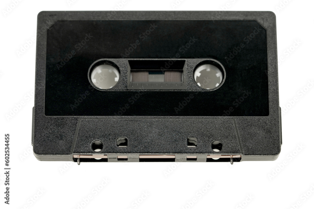Old black audio cassette without inscriptions on a white background. Old black audio cassette without inscriptions on a white background.