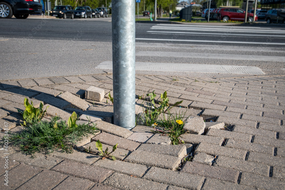 Damaged pavement on the pedestrian sidewalk. Highway and cars - obrazy, fototapety, plakaty 