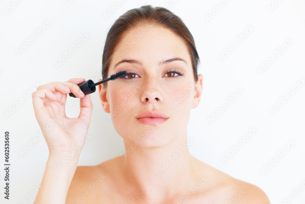 Makeup, beauty and portrait of woman with mascara in studio for volume or grooming on white background. Face, eyelashes and girl model with lash, brush or tool, luxury and cosmetics product isolated Makeup, beauty and portrait of woman with mascara in studio for volume or grooming on white background. Face, eyelashes and girl model with lash, brush or tool, luxury and cosmetics product isolated