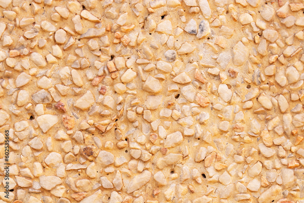 Background or texture Abstract of pebbles small or gravel color yellow, orange attached with beautiful cement concrete. Natural pattern used to make wallpaper website along walls of houses, building. Background or texture Abstract of pebbles small or gravel color yellow, orange attached with beautiful cement concrete. Natural pattern used to make wallpaper website along walls of houses, building.