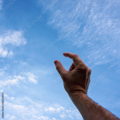 hand up gesturing in the blue sky, feelings and emotions