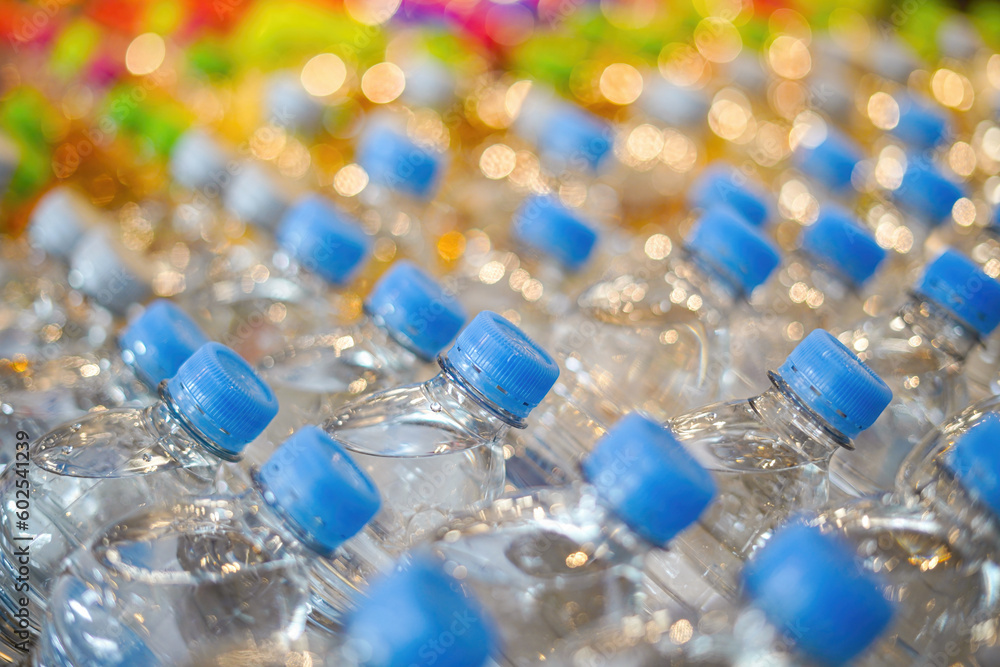 plastic transparent water bottles for drinking on a warehouse showcase in a stor plastic transparent water bottles for drinking on a warehouse showcase in a stor