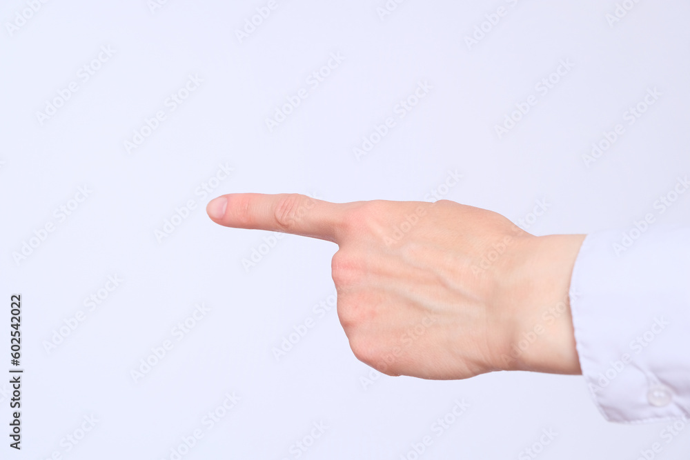 The index finger of the female hand shows the direction The index finger of the female hand shows the direction