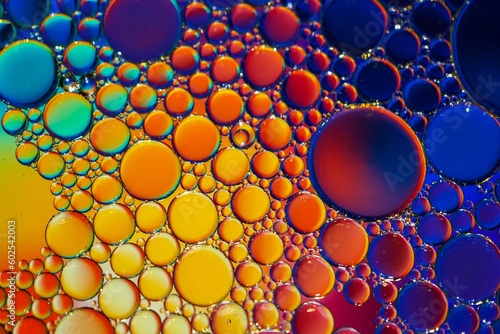 multi colored oil circles on the water, colorful background