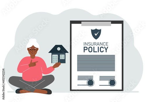 A woman holds in his hands at home next to a large insurance contract. Home and real estate insurance concept.